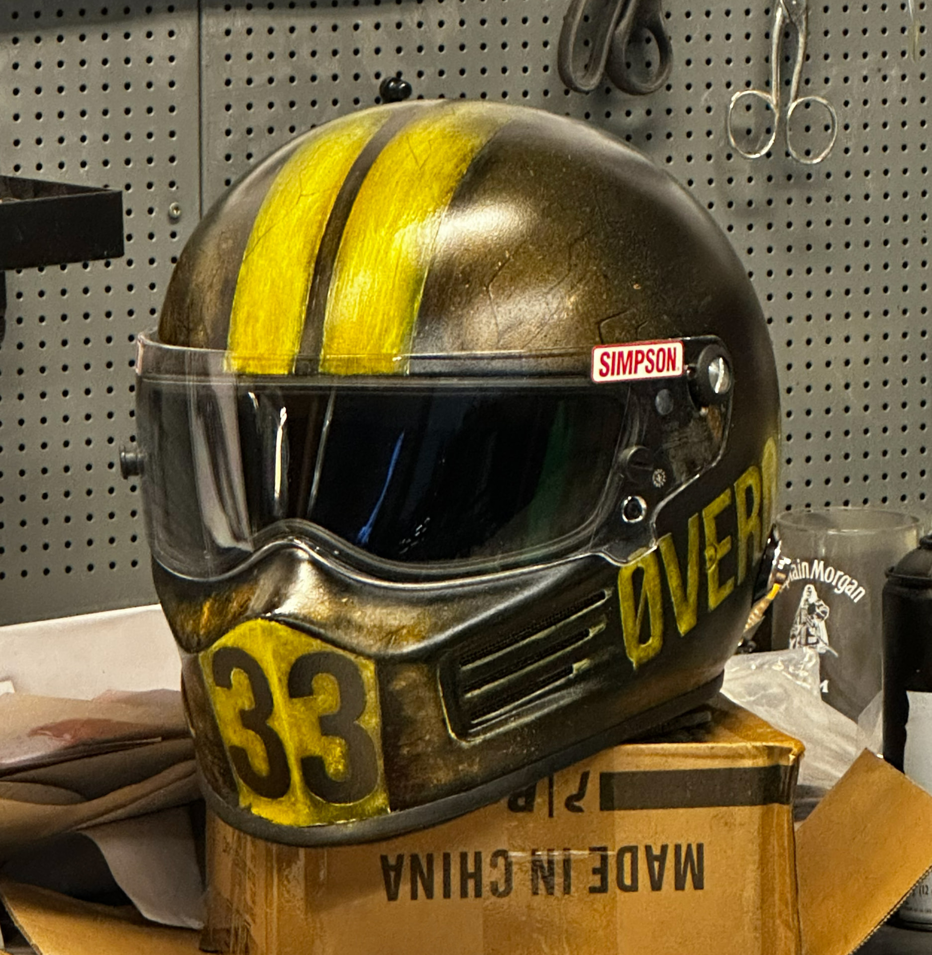 Simpson helmet with hand-painted yellow racing stripes and number 33