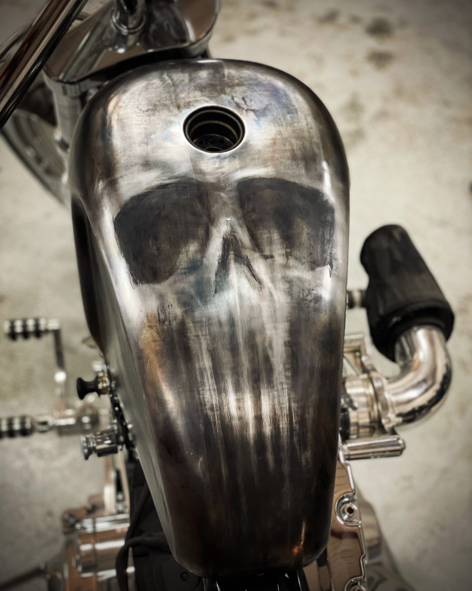 Skull painted on a bare metal tank