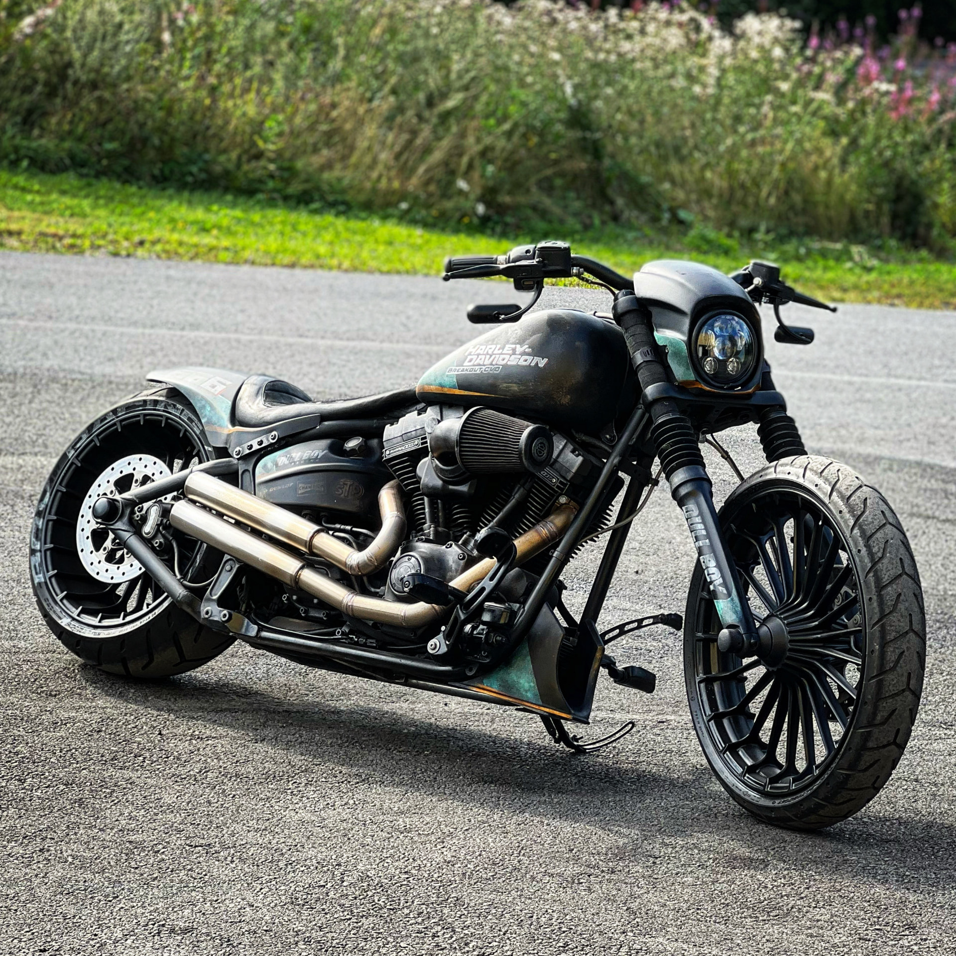 Breakout CVO custom Harley with patina paint parked on asphalt