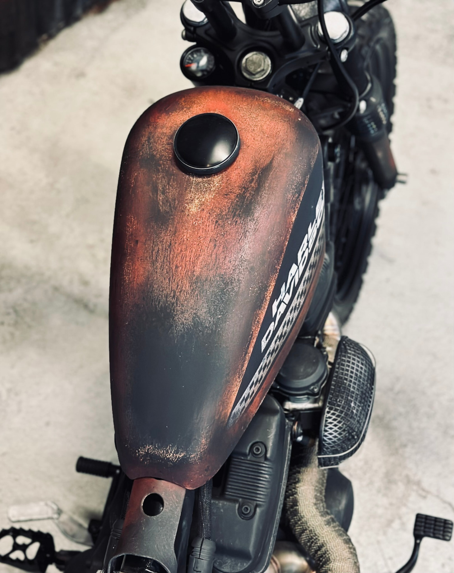 Rust-effect painted Harley tank with hand-laid lettering